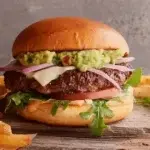 Restaurant-style Avocado Smash Burger served with lettuce, tomato, and fresh toppings.