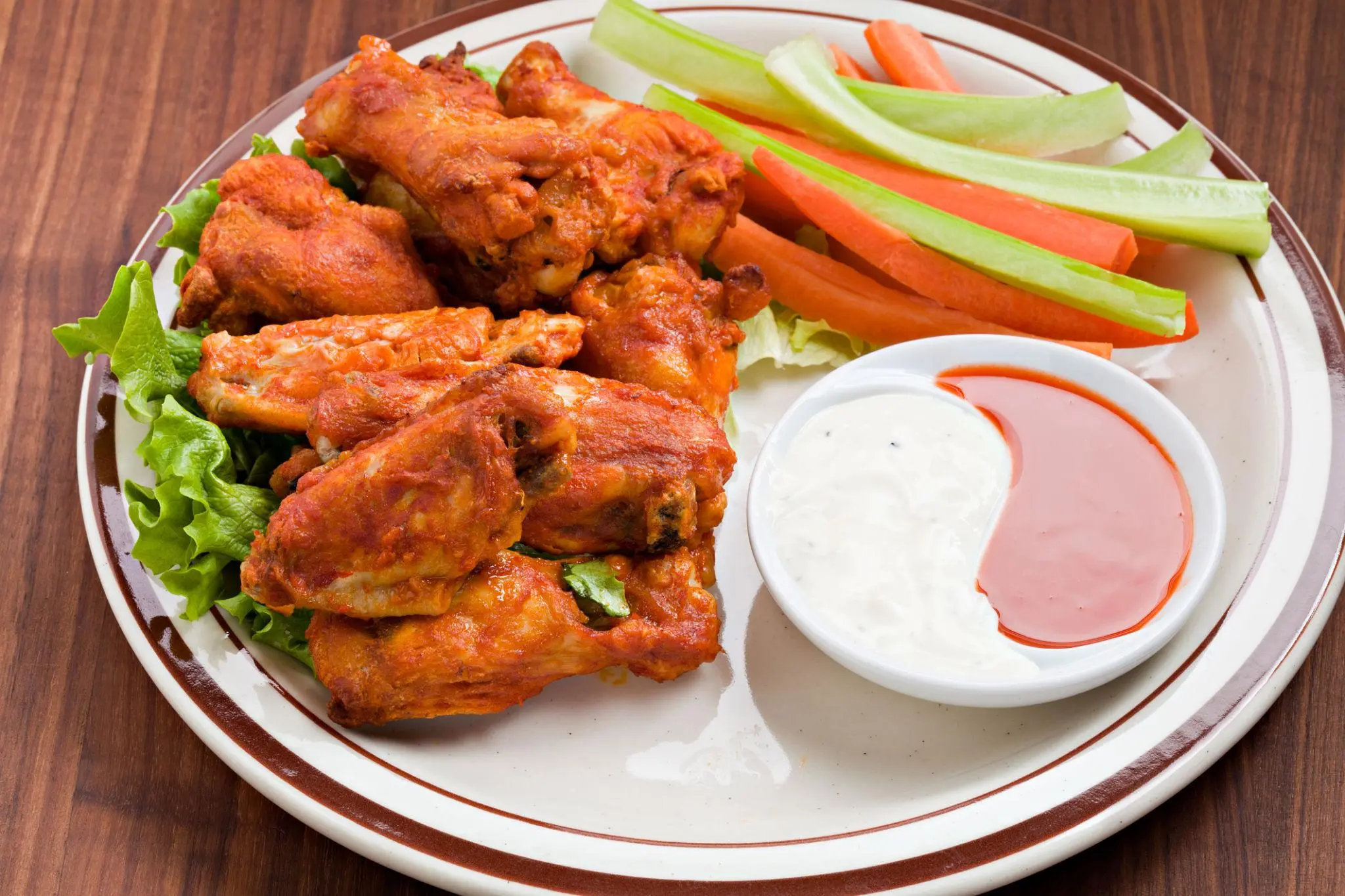 Nutrition 2 Twin Peaks bone-in chicken wings served crispy with buffalo sauce, ranch dressing, and fresh celery sticks