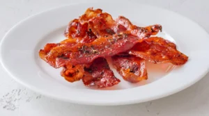 Crispy Billionaire's Bacon served as a flavorful appetizer with a caramelized finish.